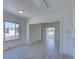 Bright living room with natural light, neutral paint, and a smooth transition to the next room at 5723 Zephyr St, Arvada, CO 80002