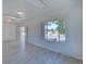 Spacious living room featuring neutral walls, modern lighting, and multiple doorways for a connected living space at 5723 Zephyr St, Arvada, CO 80002