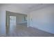 Spacious living room featuring neutral walls, multiple doorways, and open layout to other rooms in the home at 5723 Zephyr St, Arvada, CO 80002