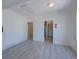 Spacious living room featuring neutral walls, multiple doorways, and open layout to other rooms in the home at 5723 Zephyr St, Arvada, CO 80002