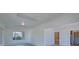 Spacious living room with neutral walls, large windows, and an open layout to other rooms in the home at 5723 Zephyr St, Arvada, CO 80002