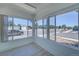 Bright sunroom features large windows offering abundant natural light and neighborhood views, with tile flooring at 5723 Zephyr St, Arvada, CO 80002