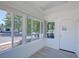 Bright sunroom features large windows offering abundant natural light and neighborhood views, with tile flooring at 5723 Zephyr St, Arvada, CO 80002
