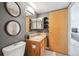 Bathroom featuring a vanity with a sink, tile countertops, and a mirror with updated lighting at 1301 Speer Blvd # 403, Denver, CO 80204