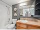 Bathroom featuring tiled walls, a vanity with a sink, and a shower/tub combination at 1301 Speer Blvd # 403, Denver, CO 80204