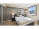 Bedroom featuring neutral paint colors, an accent wall, and a window letting in natural light at 1301 Speer Blvd # 403, Denver, CO 80204