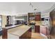 Modern kitchen featuring stainless steel appliances, wood cabinets, and an island countertop with breakfast bar at 1301 Speer Blvd # 403, Denver, CO 80204