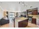 Spacious kitchen open to the living room with stainless steel appliances, an island with seating, and a bright view at 1301 Speer Blvd # 403, Denver, CO 80204