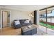 Inviting living room with a cozy gray sofa, view of the city skyline, and access to a balcony at 1301 Speer Blvd # 403, Denver, CO 80204