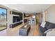 Modern living room with a large TV, dark wood cabinets, and an open floor plan connecting to the kitchen at 1301 Speer Blvd # 403, Denver, CO 80204