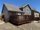 Backyard featuring a deck with stairs and a well-maintained exterior at 6610 Monaco Way, Brighton, CO 80602