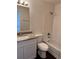 Bathroom featuring granite counters, white vanity and shower-tub combo at 6610 Monaco Way, Brighton, CO 80602