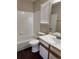 Bathroom featuring a tub-shower combo, white tile and single-sink vanity at 6610 Monaco Way, Brighton, CO 80602