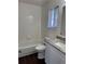 Clean bathroom with white tile, granite vanity, and modern fixtures at 6610 Monaco Way, Brighton, CO 80602