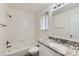 Bright bathroom with updated vanity, granite countertops, and tiled shower at 6610 Monaco Way, Brighton, CO 80602
