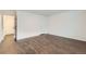 Bedroom with wood-look floors and white door at 6610 Monaco Way, Brighton, CO 80602