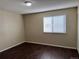 Bedroom featuring wood-look floors, neutral walls and window with blinds at 6610 Monaco Way, Brighton, CO 80602