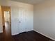 Hardwood floor bedroom with neutral walls and an open doorway to other rooms at 6610 Monaco Way, Brighton, CO 80602