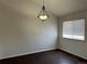 Dining room with hardwood floors and elegant chandelier lighting fixture at 6610 Monaco Way, Brighton, CO 80602