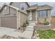 Charming two-story brick and siding home featuring an attached garage and landscaped front yard at 6610 Monaco Way, Brighton, CO 80602