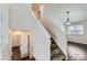 Carpeted stairs lead to rooms with fresh paint and modern wood floors at 6610 Monaco Way, Brighton, CO 80602