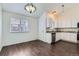 Eat-in kitchen featuring stainless steel appliances, granite countertops, and wood floors at 6610 Monaco Way, Brighton, CO 80602