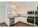 Bright eat-in kitchen featuring white cabinets, granite countertops, and stainless steel appliances at 6610 Monaco Way, Brighton, CO 80602