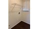 Laundry room featuring shelving, hardwood-style flooring and utility hookups at 6610 Monaco Way, Brighton, CO 80602