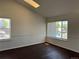 Bright living room featuring hardwood floors, large windows, and neutral paint colors at 6610 Monaco Way, Brighton, CO 80602