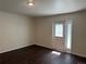 Living room featuring a door with blinds and hardwood-style floors at 6610 Monaco Way, Brighton, CO 80602
