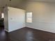 Open living area with hardwood floors and ample natural light from a large window at 6610 Monaco Way, Brighton, CO 80602