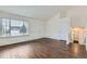 Open living area with wood floors, bright natural light, and vaulted ceilings at 6610 Monaco Way, Brighton, CO 80602
