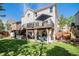 Expansive backyard view showcasing a deck, patio, and lush lawn, perfect for outdoor living at 6039 S Ukraine Cir, Aurora, CO 80015