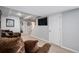 Basement living room with a comfortable sectional and a wall-mounted TV at 6039 S Ukraine Cir, Aurora, CO 80015
