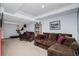 Finished basement with a brown sectional, treadmill, and entertainment area at 6039 S Ukraine Cir, Aurora, CO 80015
