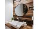 Stylish bathroom featuring wood-look accent wall, a vessel sink, and modern fixtures at 6039 S Ukraine Cir, Aurora, CO 80015