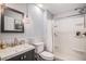 Bathroom with a gray vanity, modern fixtures, and a shower-tub combination at 6039 S Ukraine Cir, Aurora, CO 80015