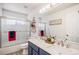 Bathroom with a double sink vanity, a large mirror, and a shower with sliding doors at 6039 S Ukraine Cir, Aurora, CO 80015