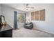 Comfortable bedroom featuring a gray chair, natural light, and wall art at 6039 S Ukraine Cir, Aurora, CO 80015