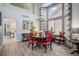Elegant dining area featuring a round table with six chairs, hardwood floors, and a stylish chandelier at 6039 S Ukraine Cir, Aurora, CO 80015