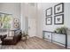 Bright entryway with wood floors, white walls, and a high ceiling, complemented by stylish furniture and decor at 6039 S Ukraine Cir, Aurora, CO 80015