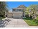 Inviting two-story home with a well-maintained lawn, a three-car garage, and charming curb appeal on a sunny day at 6039 S Ukraine Cir, Aurora, CO 80015
