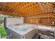 Inviting hot tub beneath a wooden pergola, creating a relaxing outdoor oasis at 6039 S Ukraine Cir, Aurora, CO 80015
