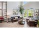 Bright living room with neutral walls, hardwood floors, natural light, and leather sofa with accent pillows at 6039 S Ukraine Cir, Aurora, CO 80015