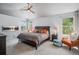 Relaxing main bedroom featuring a modern electric fireplace and comfortable furnishings with natural light at 6039 S Ukraine Cir, Aurora, CO 80015