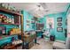 Home office space with blue walls, built-in shelving, and modern decor at 6039 S Ukraine Cir, Aurora, CO 80015