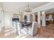 Formal dining room featuring a fireplace, a chandelier, and sunlit windows at 2975 E Wesley Ave, Denver, CO 80210