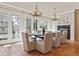 Dining room with patio view, elegant seating, and chandelier lighting at 2975 E Wesley Ave, Denver, CO 80210