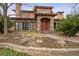 Beautiful two-story home with red front door, landscaped yard, and stone accents at 2975 E Wesley Ave, Denver, CO 80210