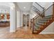 Bright hallway with terra cotta tile, access to the kitchen, staircase, and open French doors at 2975 E Wesley Ave, Denver, CO 80210